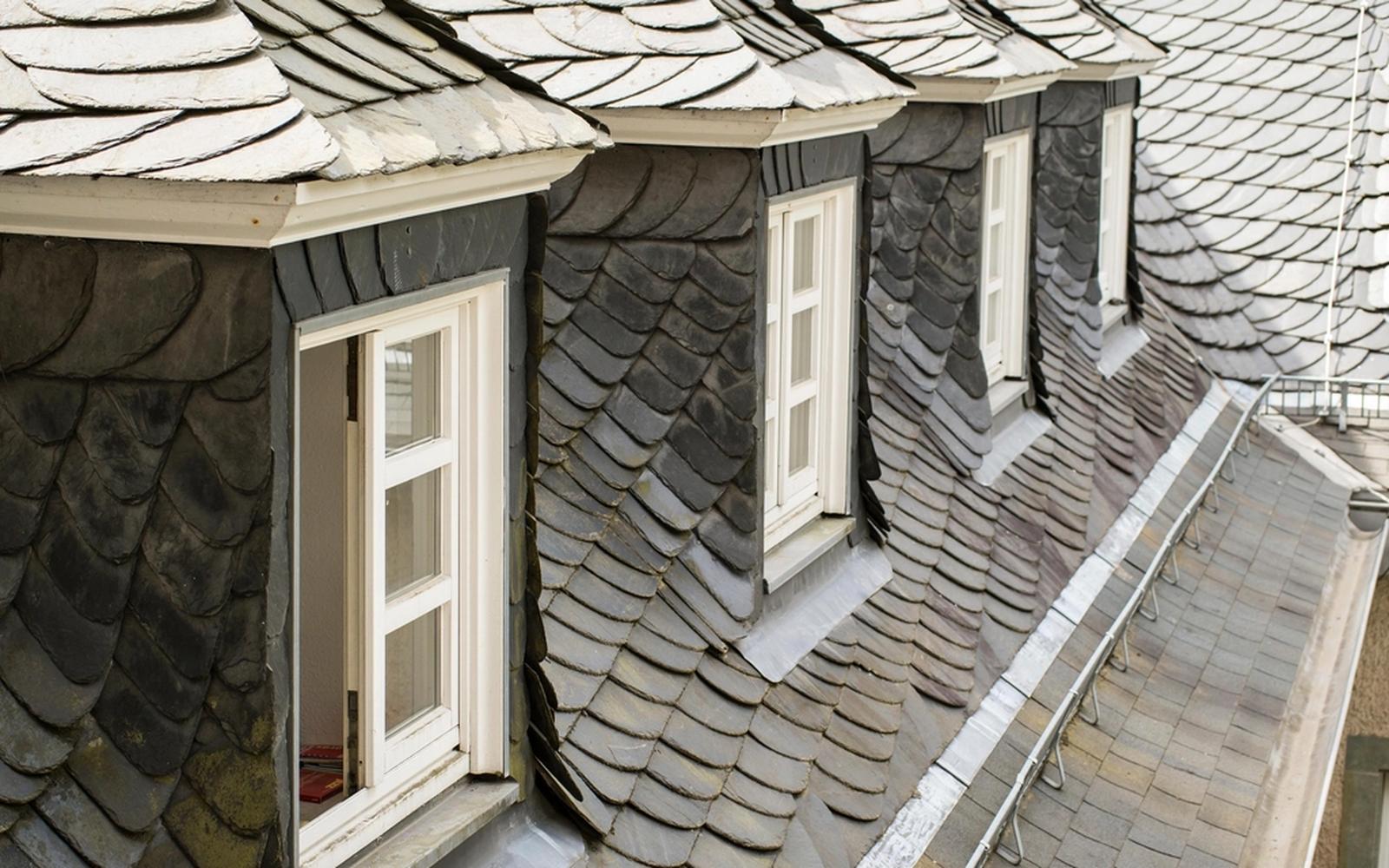 A slate roof with dormer windows